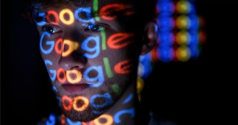 The Google logo is projected onto a man on August 09, 2017 in London.