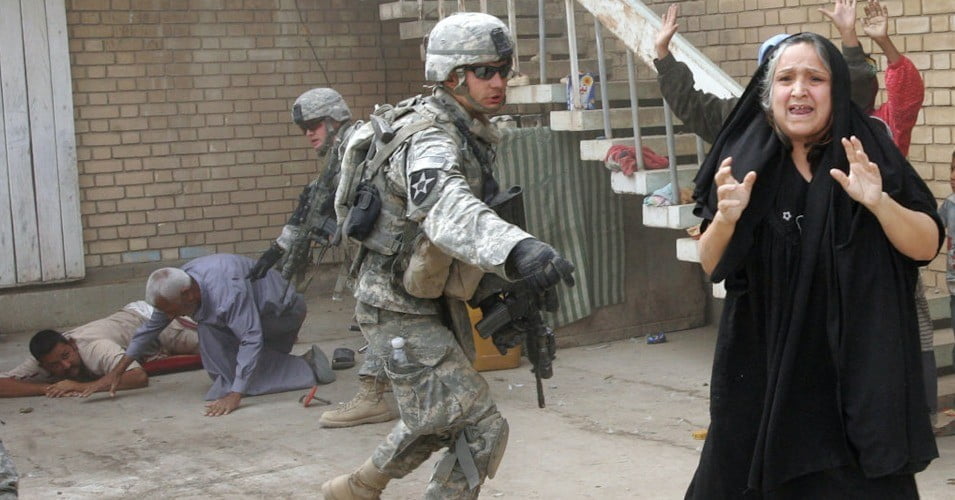 U.S. troops search an Iraqi family near Baquba on October 5, 2007. (Photo: Alexander Nemenov/AFP/Getty Images)