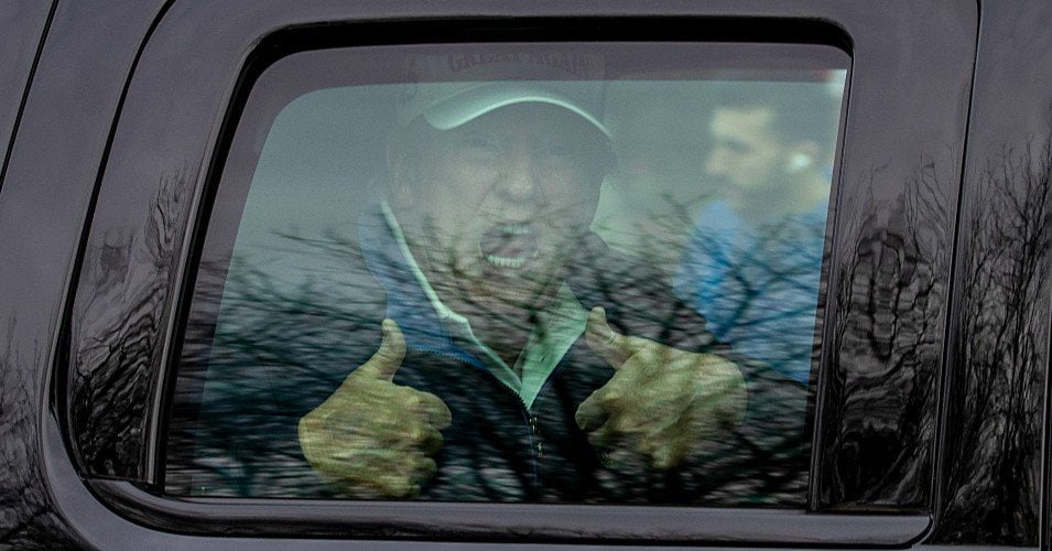 U.S. President Donald Trump gives thumbs up to supporters from this motorcade after he golfed at Trump National Golf Club on November 22, 2020 in Sterling, Virginia. The previous day Preisdent Donald Trump left a G20 summit virtual event “Pandemic Preparedness” to visit one of his golf clubs as virus has now killed more than 250,000 Americans. (Photo: Tasos Katopodis/Getty Images)