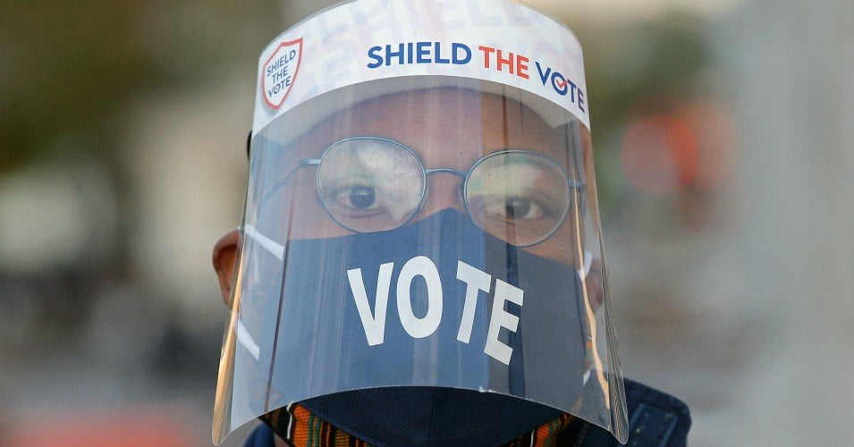 A voter wears a face mask and a face shield outside a polling station on Election Day during the 2020 general elections. (Photo: Yegor AleyevTASS via Getty Images)