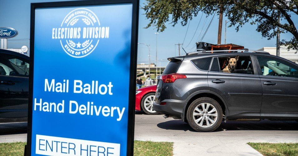 Cars approach a mail-in ballot drop off location on October 13, 2020 in Austin, Texas.